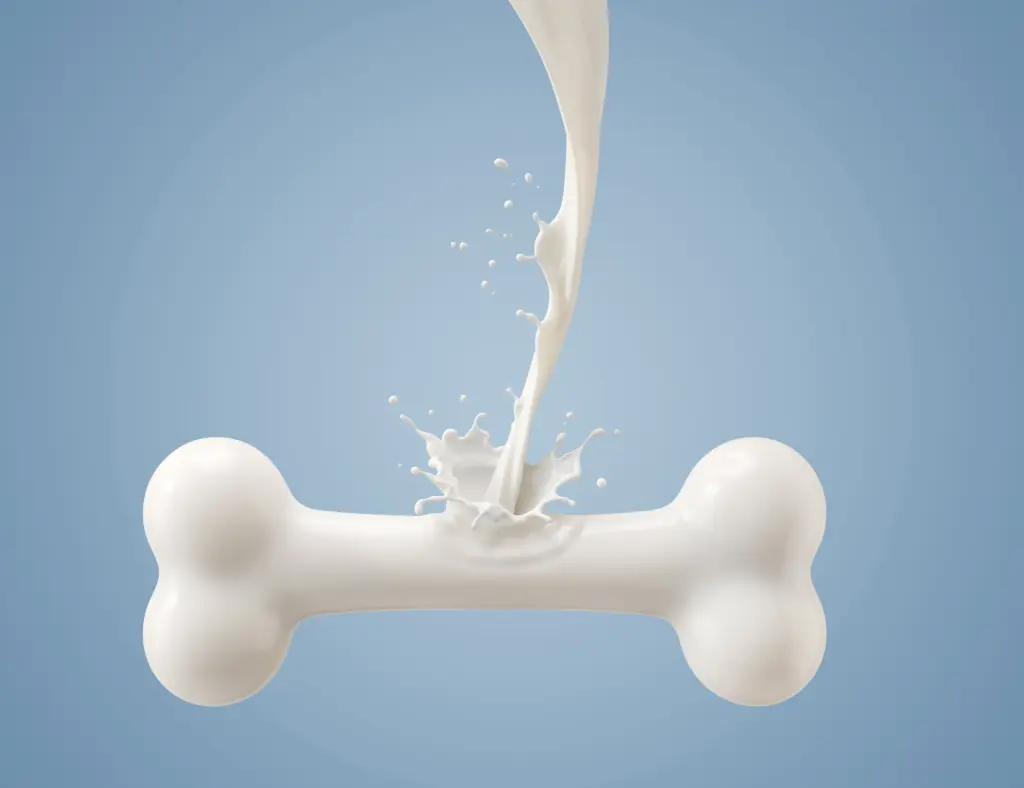 Calcium und Vitamin im Körper für starke Knochen & Muskeln! 49 Milch spritzt auf weißen Knochen vor blauem Hintergrund – Symbol für Kalzium und Knochengesundheit, Calcium, Calcium Mangel Symptome, Calcium Mangel